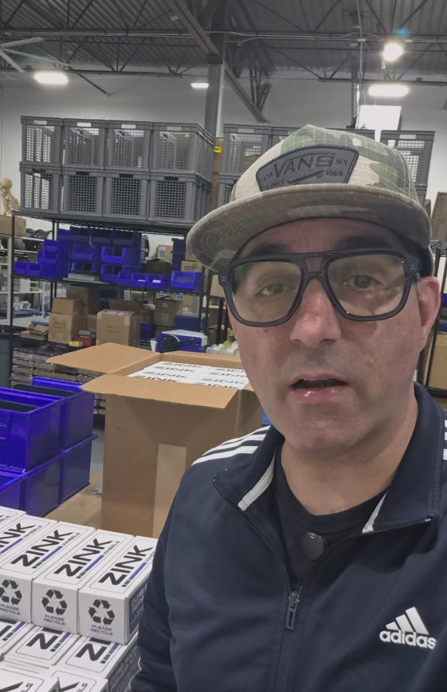Tony Zink in the Zink Wheels shop, with boxed Zink Wheels products and parts shelving behind him